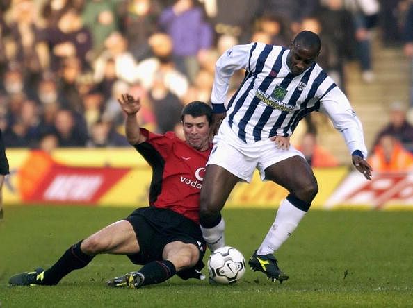 Keane of Man Utd tackles Roberts of West Brom